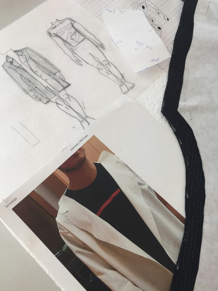 Minimal fashion workspace with fabric samples and design sketches on neutral table